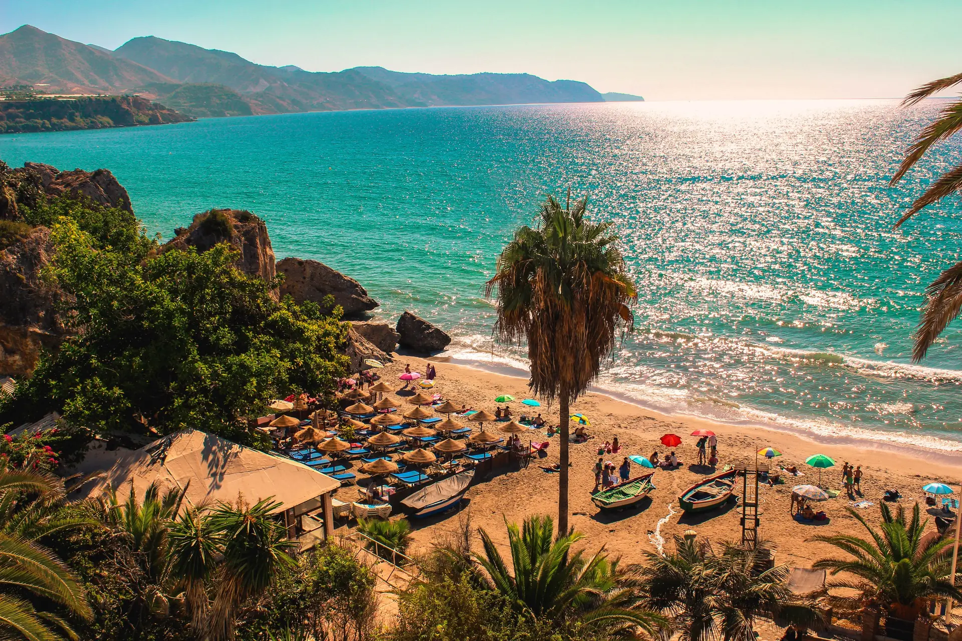 Nerja beach on the Costa del Sol, with turquoise water and a white village above the sand